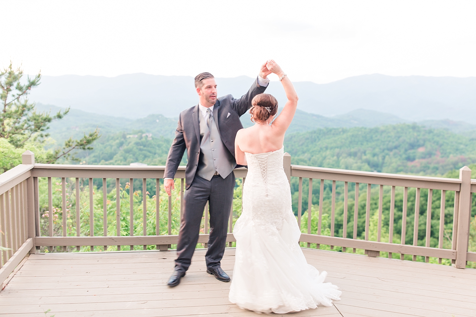 Hawkesdene Wedding Bride and Groom Twirling With View of Mountains Photo