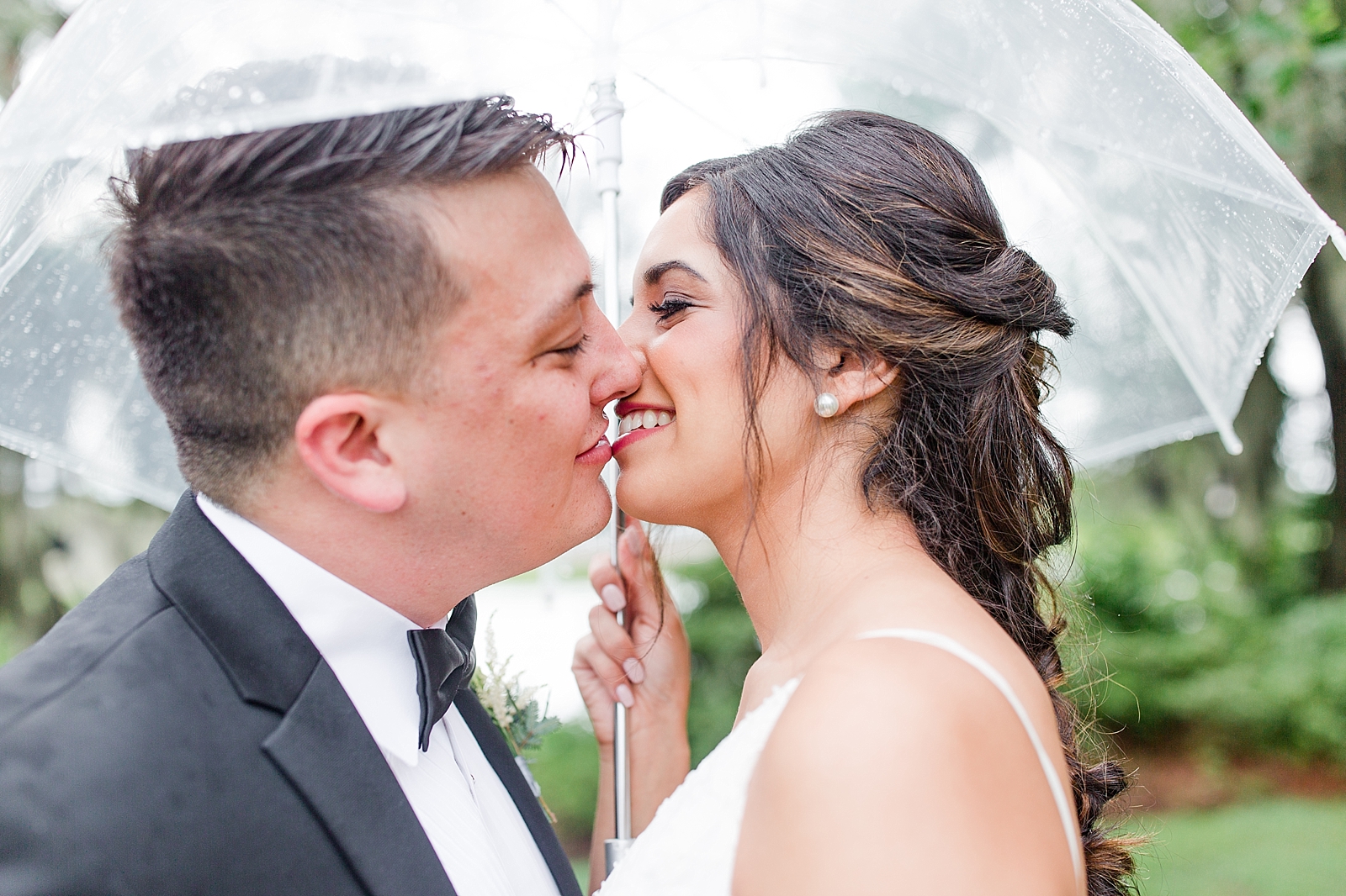 Magnolia Plantation Wedding Bride and Groom Kissing Under Umbrella Photo