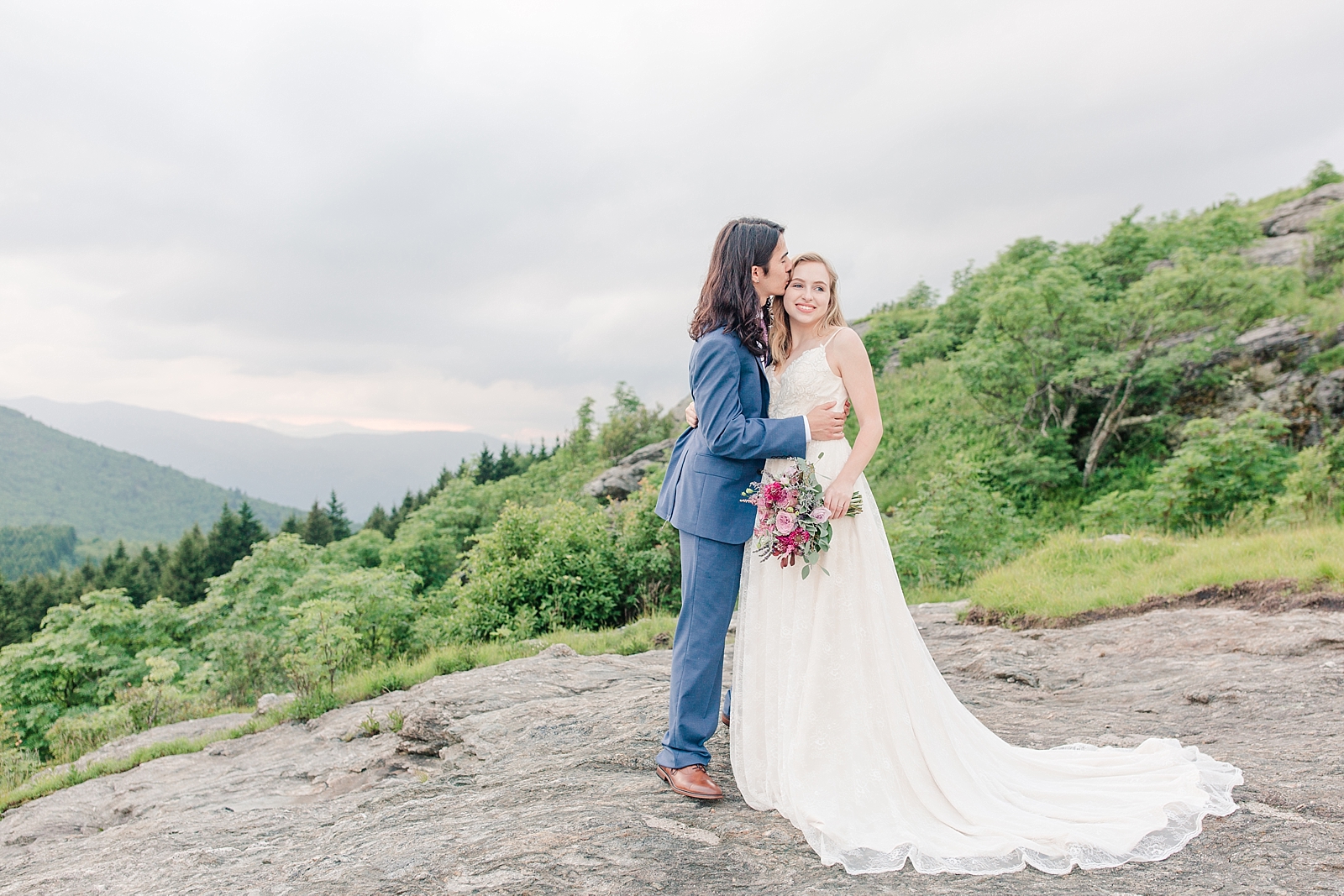 Black Balsam Knob Elopement Andrew kissing Emma with mountain background Photo