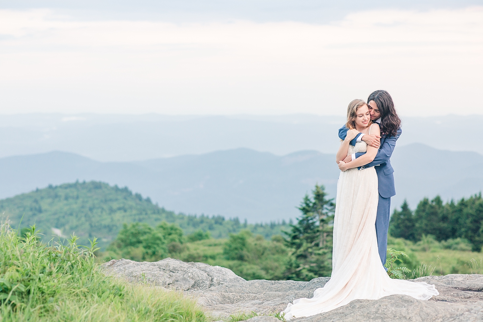 Black Balsam Knob Elopement Groom Hugging Bride with Mountain backdrop Photo