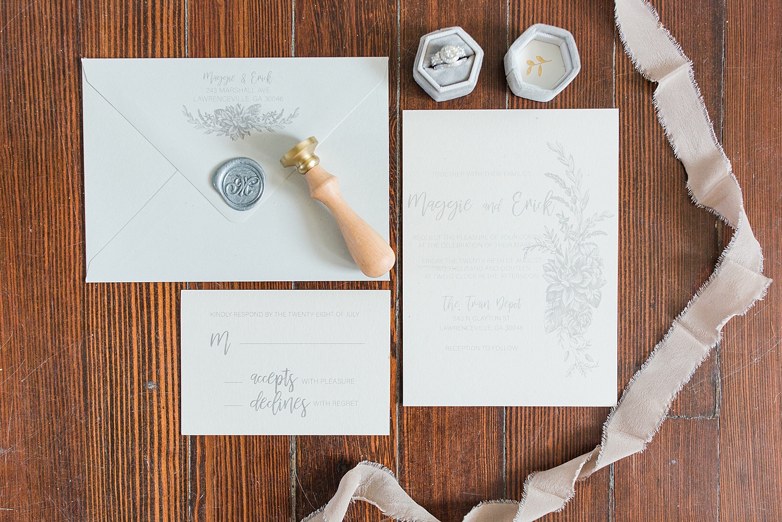 Atlanta Georgia Wedding invitation suite on wood floor with wax stamp and wedding ring Photo