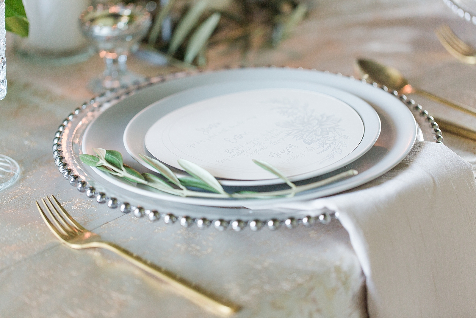 Atlanta Georgia Wedding reception place setting with grey plates and gold utensils Photo