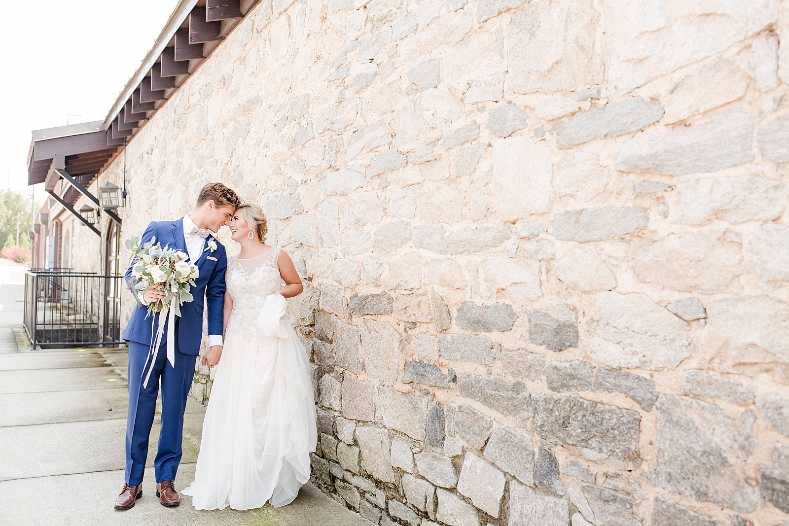 Atlanta Georgia Wedding Bride and Groom nose to nose in front of a stacked stone wall Photo