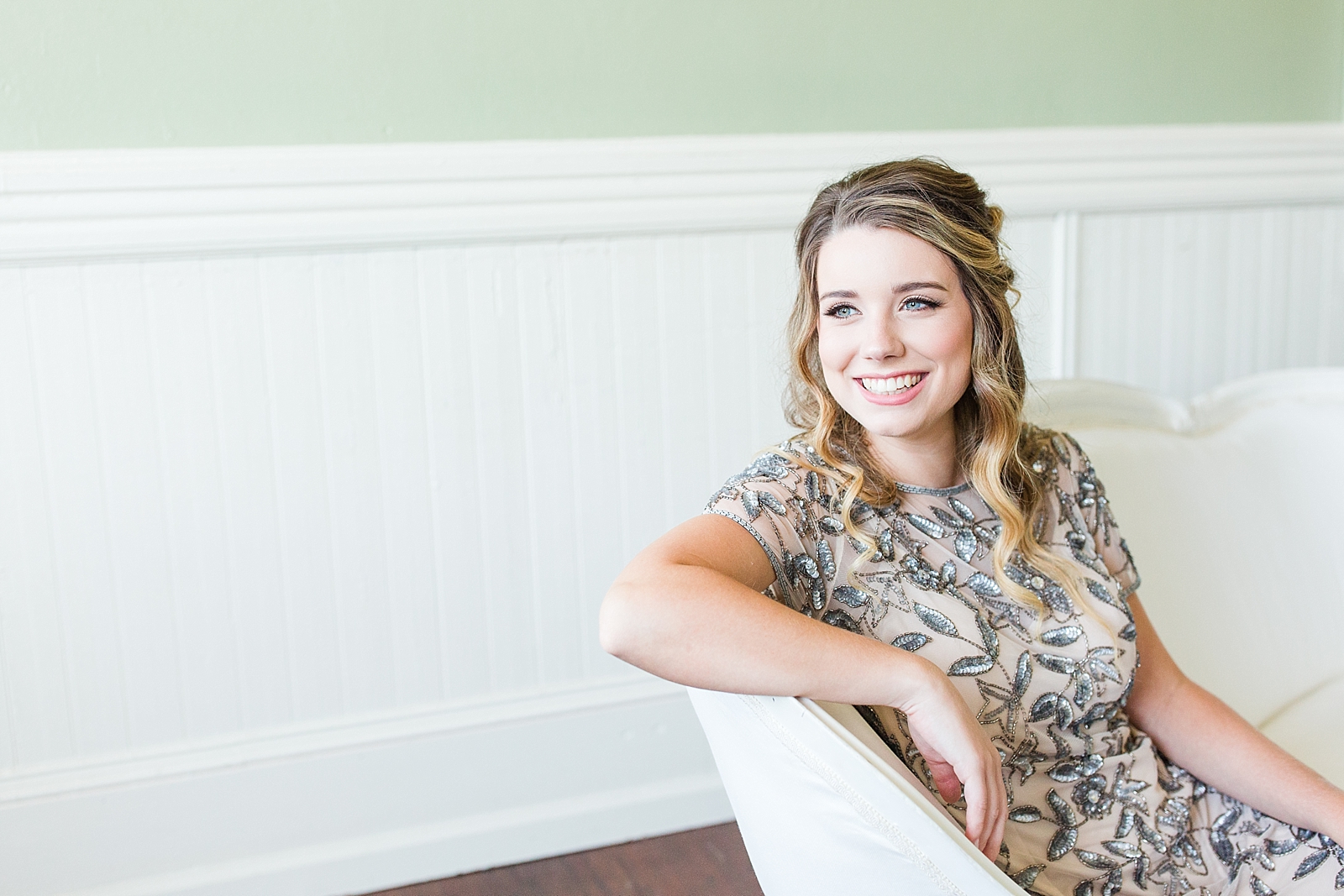 Atlanta Georgia Wedding bride on white couch in front of green wall Photo