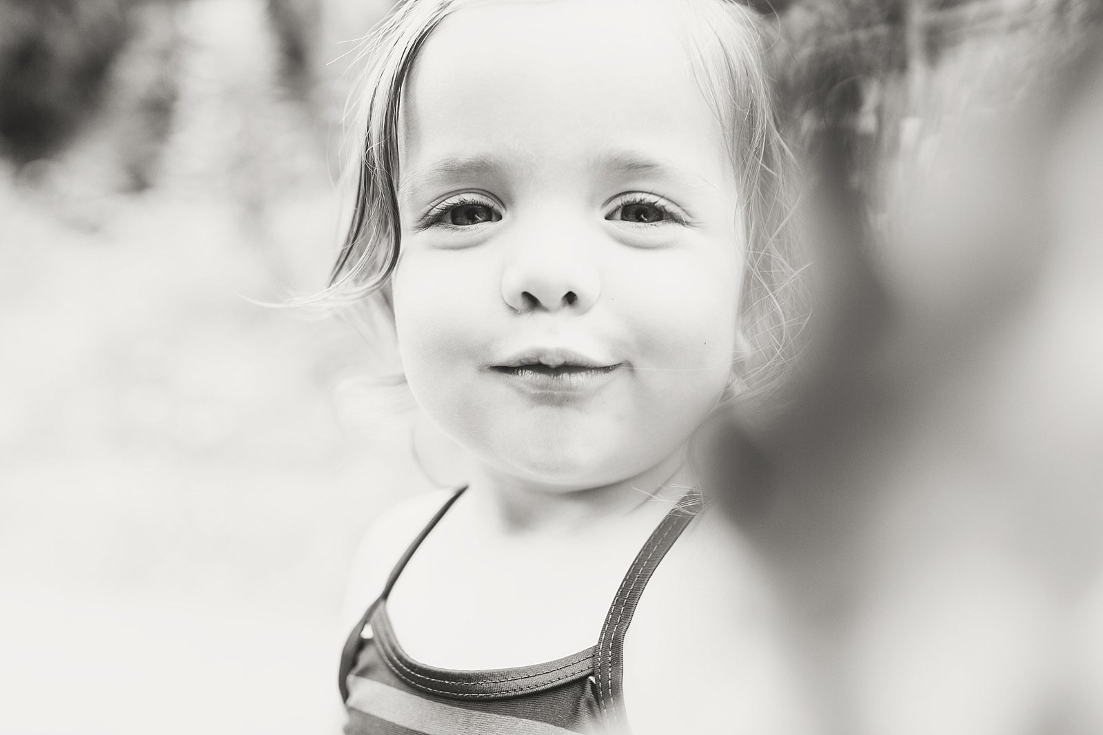 Nantahala River black and white of little girl covering camera lens photo