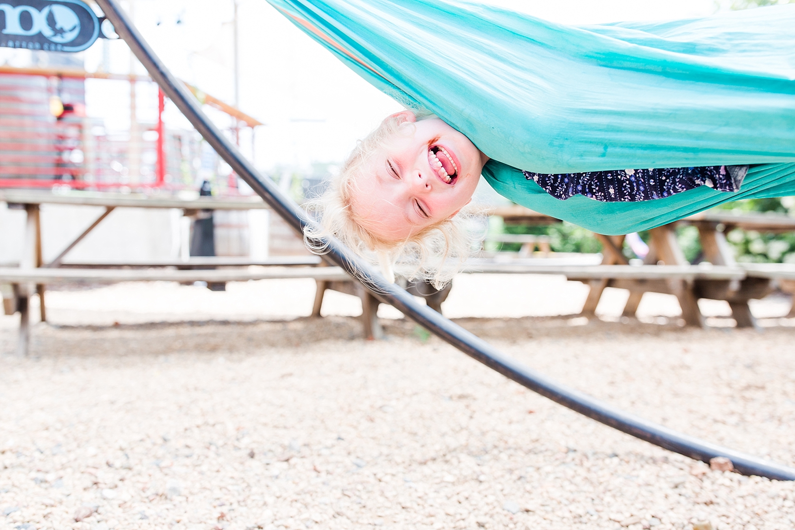 Little girl laughing in hammock upside down in Asheville NC