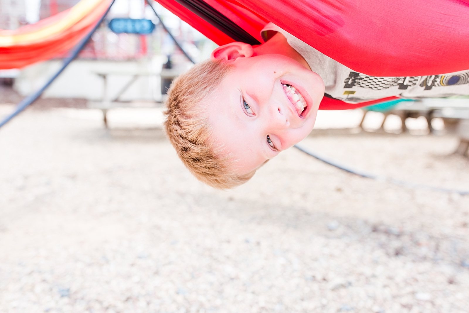 Little boy hanging upside down in hammock in Asheville NC