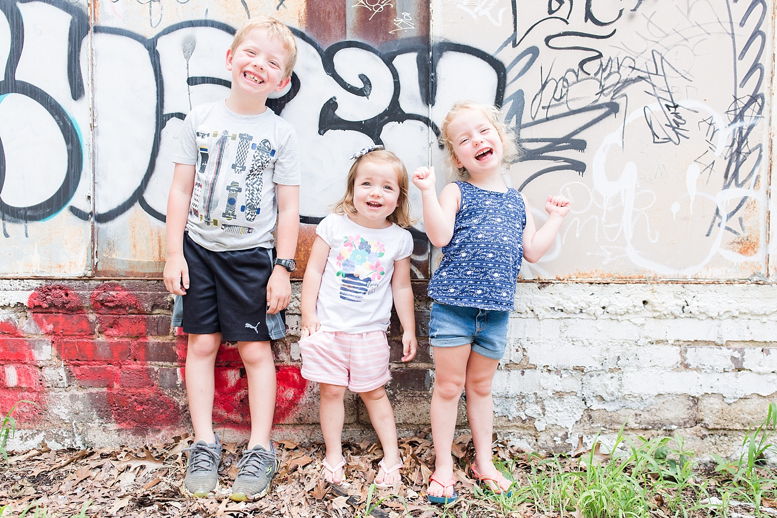Kids smiling in front of graffiti wall in Asheville NC photo