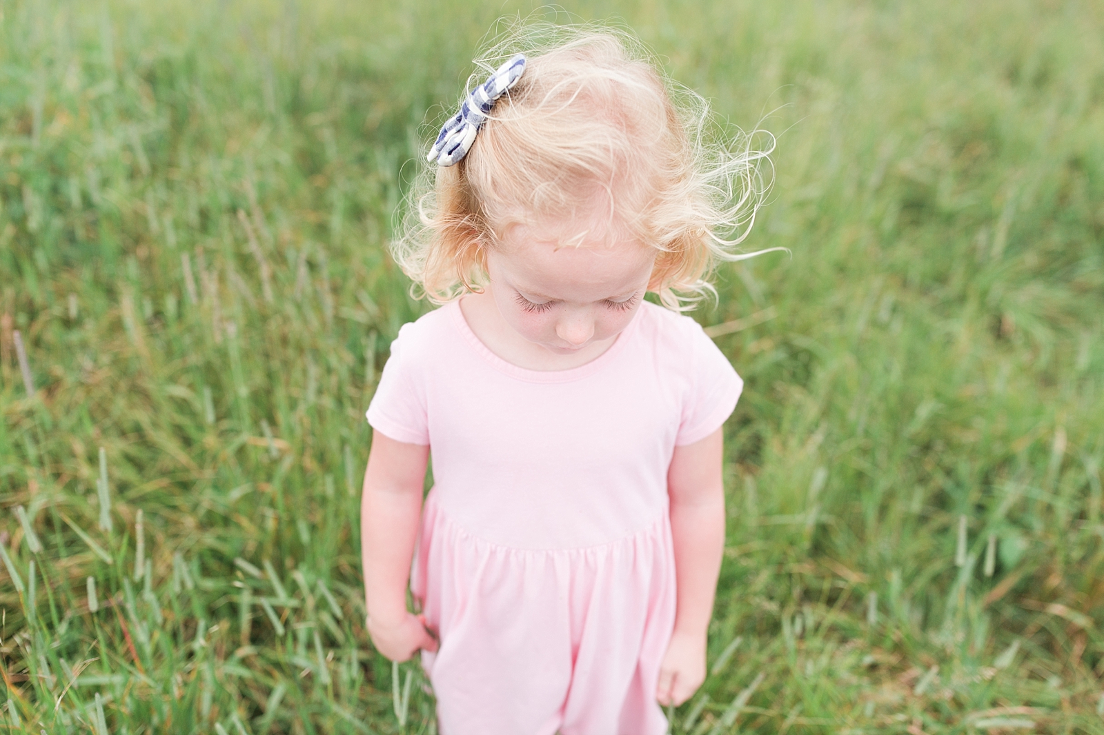 Black Balsam Knob little girl in tall grass looking at the ground with blonde hair blowing in the wind Photo