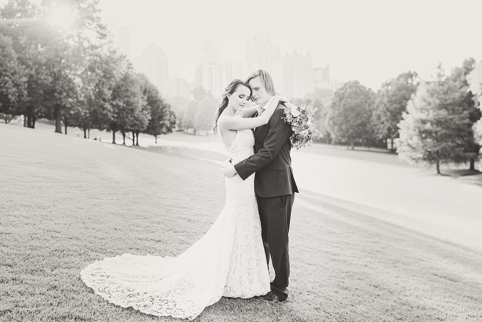 Atlanta Georgia Elopement Black and white of bride and groom in park field with Atlanta skyline Photo