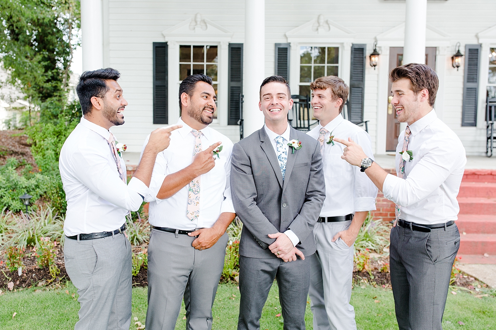 Dahlonega Wedding Venue Groom and Groomsmen laughing in front of The 1888 House Photo