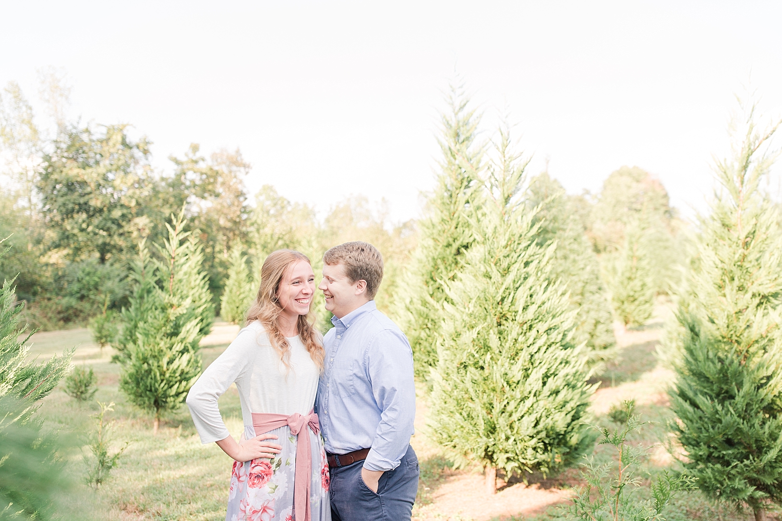 Charlotte Engagement Annabel and Bryson laughing together at a Christmas tree farm Photo