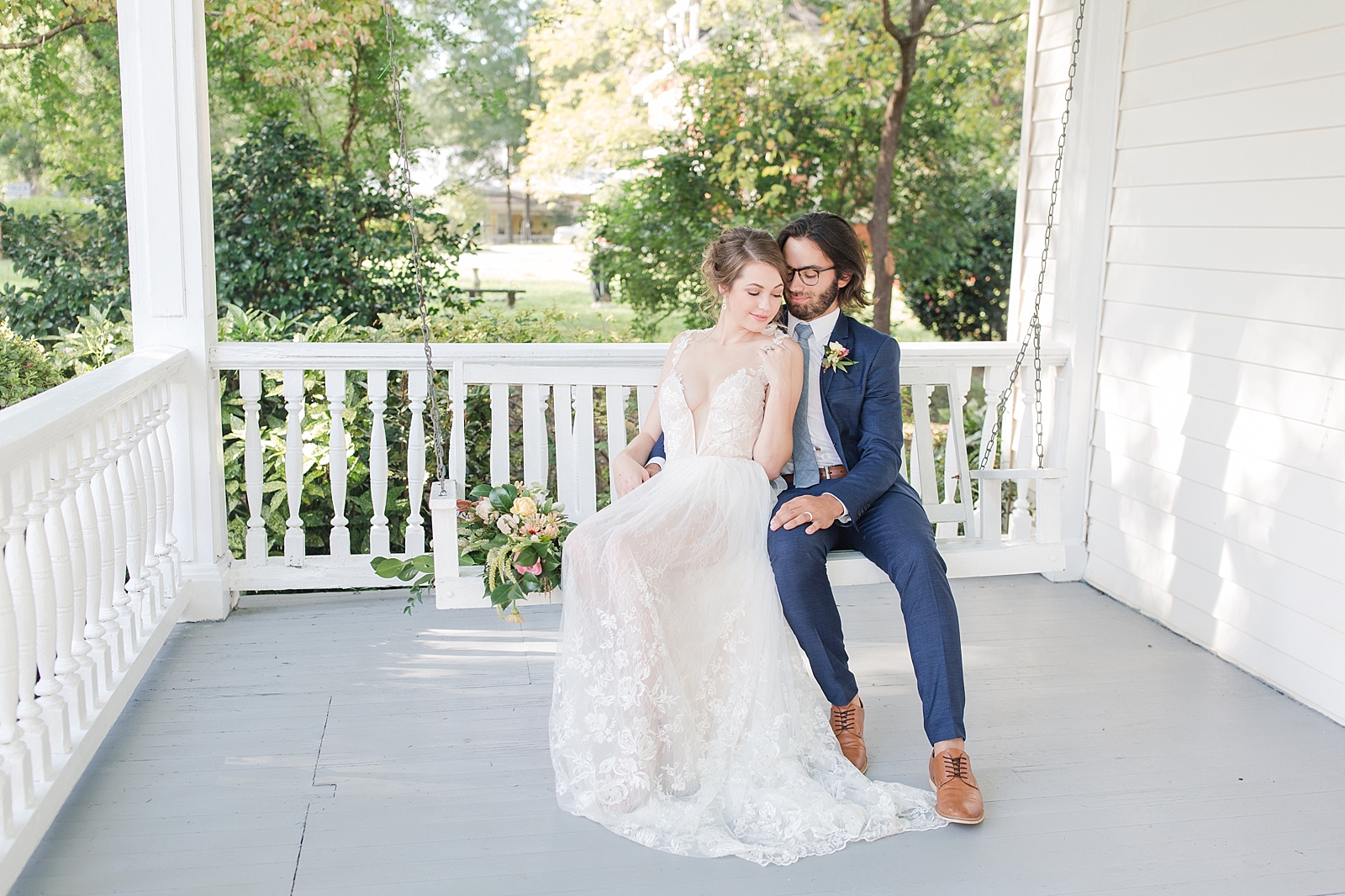 Columbia SC wedding venue bride and groom sitting on front porch swing of The Thomas House photo