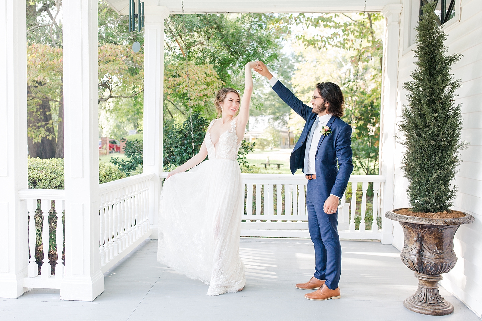 Columbia SC wedding venue groom twirling bride on front porch of The Thomas House photo