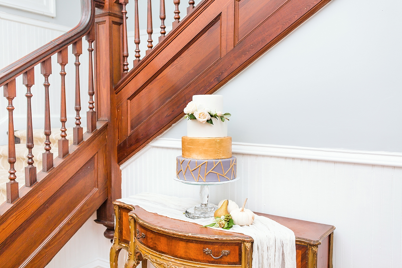 Columbia SC wedding venue cake on a table in front of staircase photo