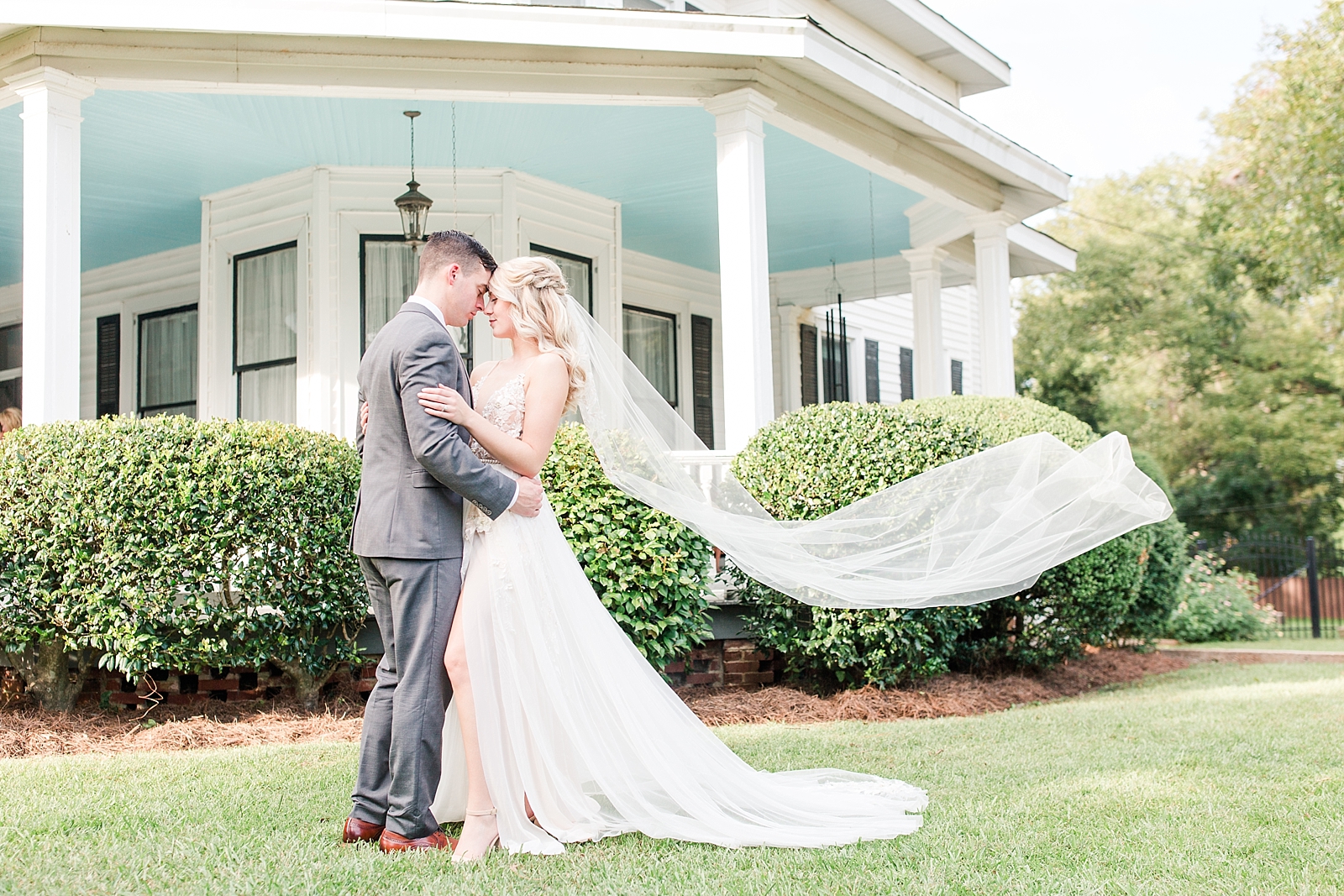 Columbia SC wedding venue bride and groom nose to nose with veil blowing in the wind photo