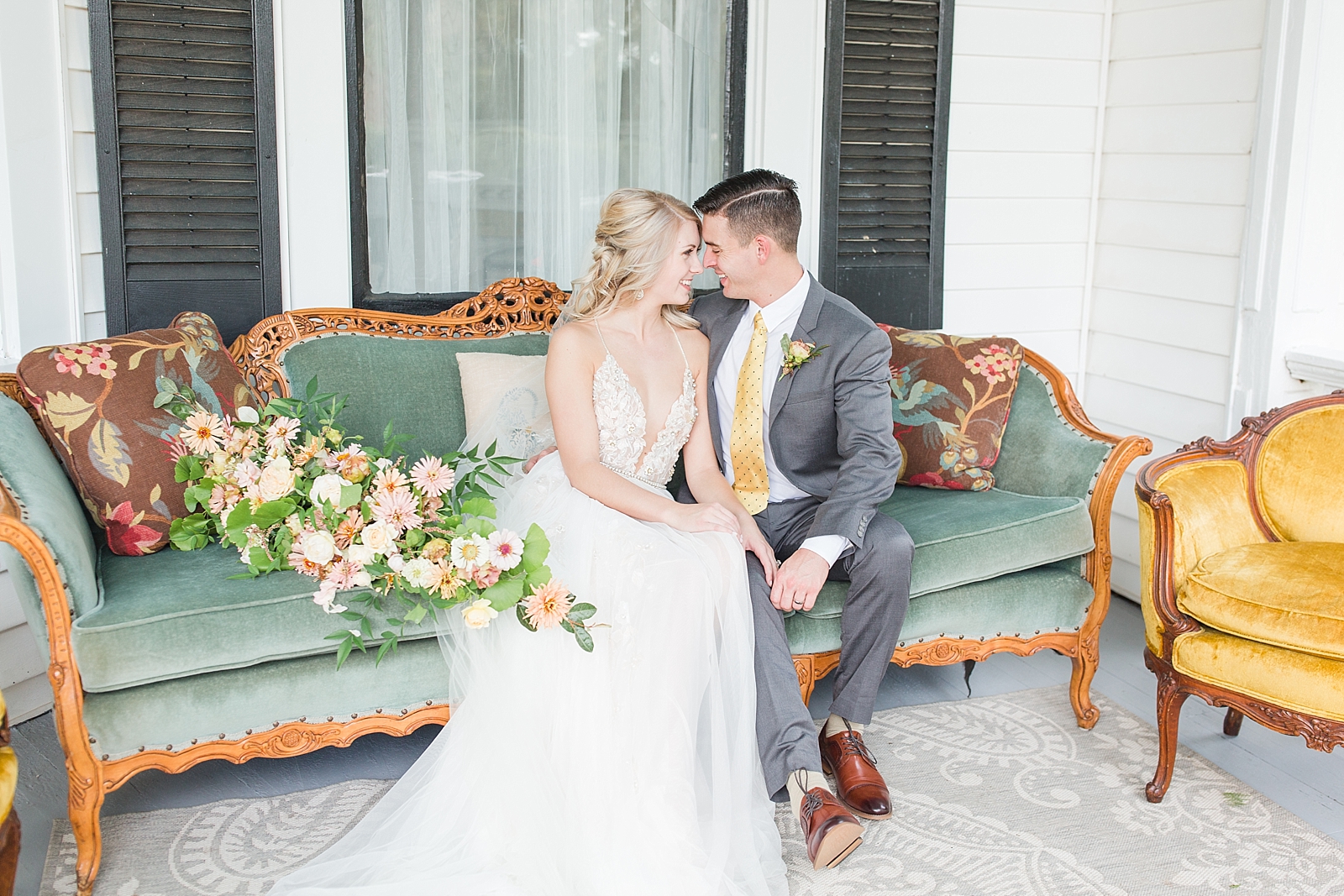 Columbia SC wedding venue bride and groom nose to nose on vintage couch photo
