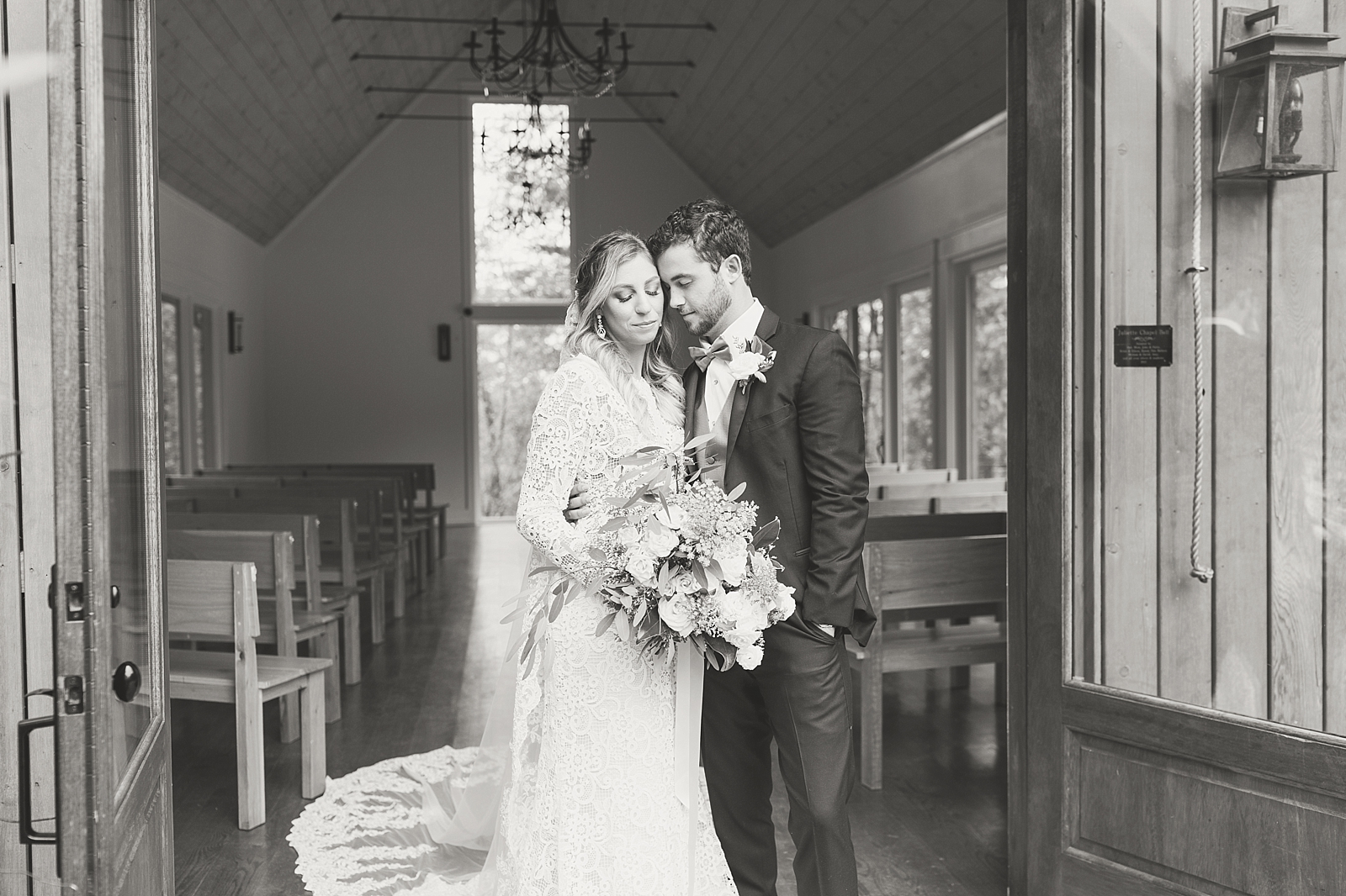 Juliette Chapel Wedding Black and White of couple snuggling at the threshold of the chapel Photo