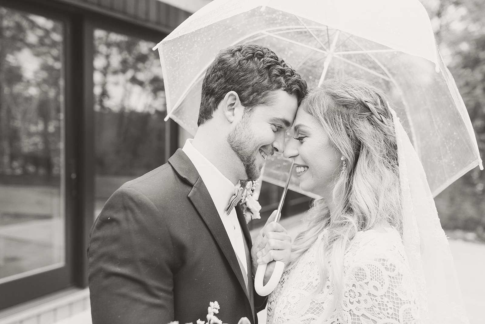 Juliette Chapel Wedding Black and White of Couple nose to nose under umbrella Photo