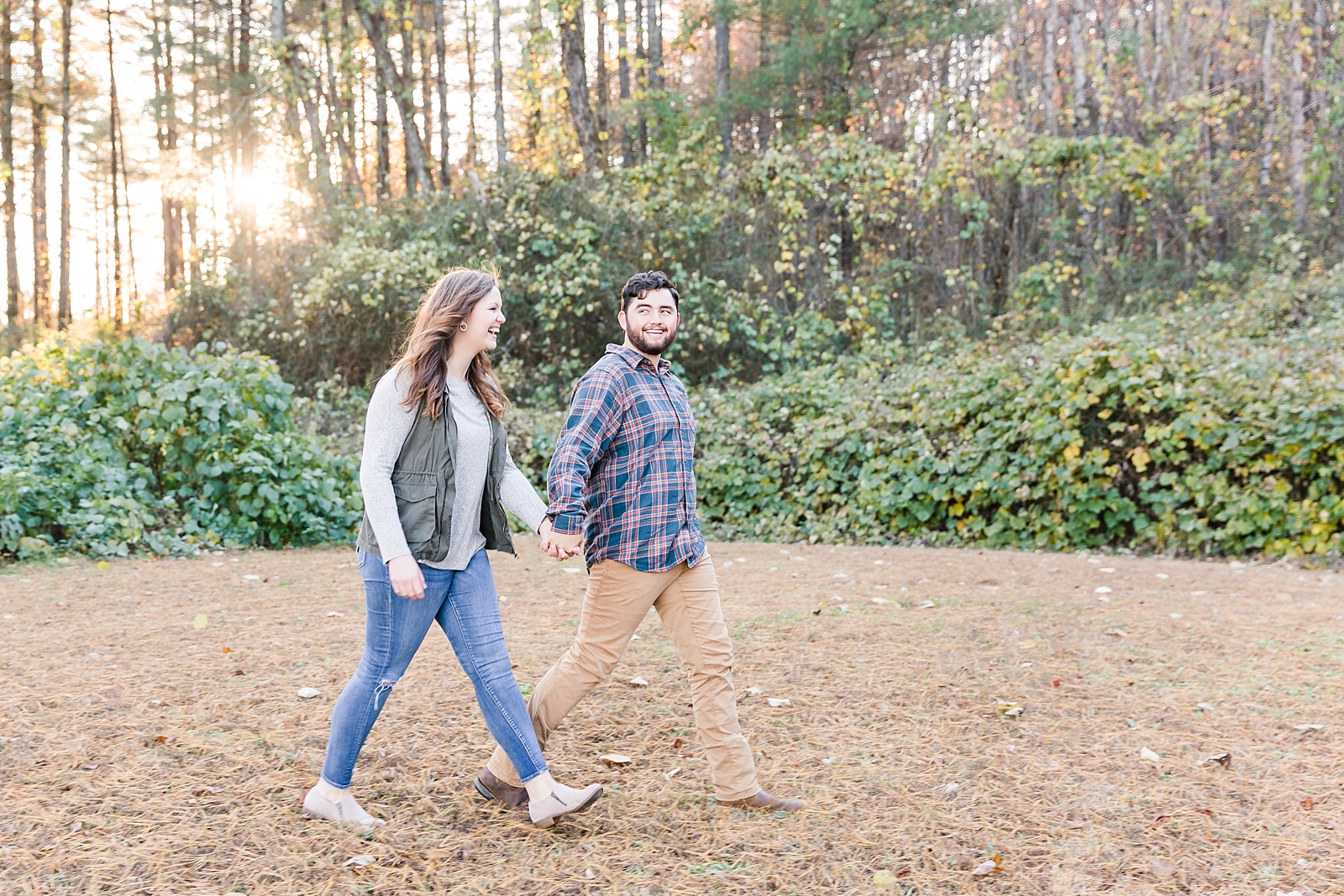 North Carolina Mountains Engagement Couple walking holding hands laughing Photo