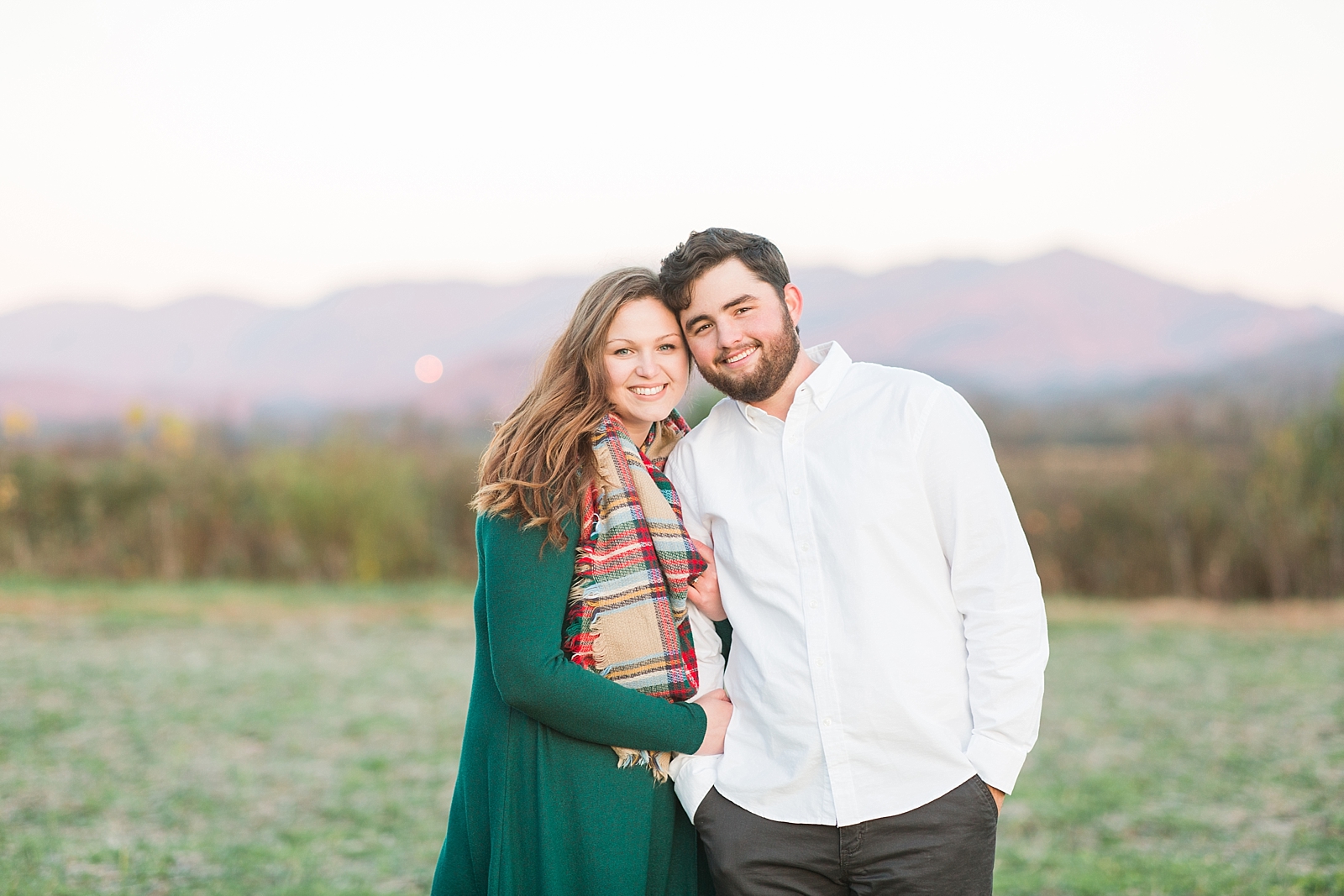 North Carolina Mountains Engagement Couple smiling at the camera with mountain background Photo