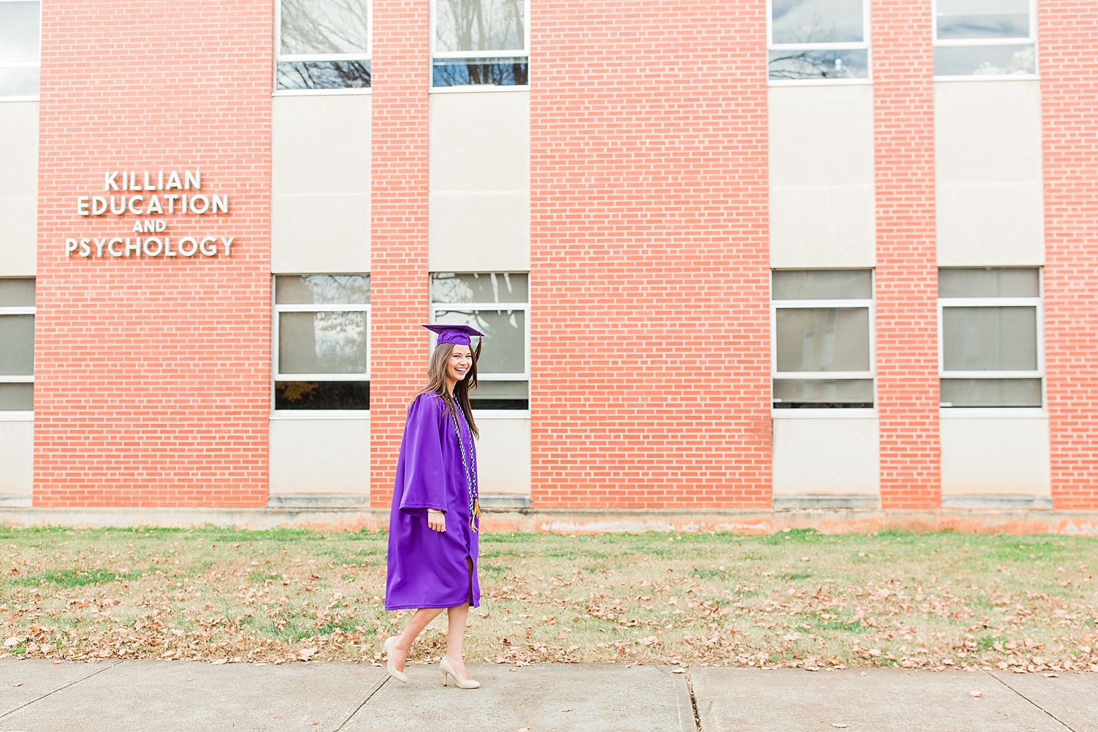 Western Carolina University Senior Sierra walking in front of the Killian education and psychology building Photo