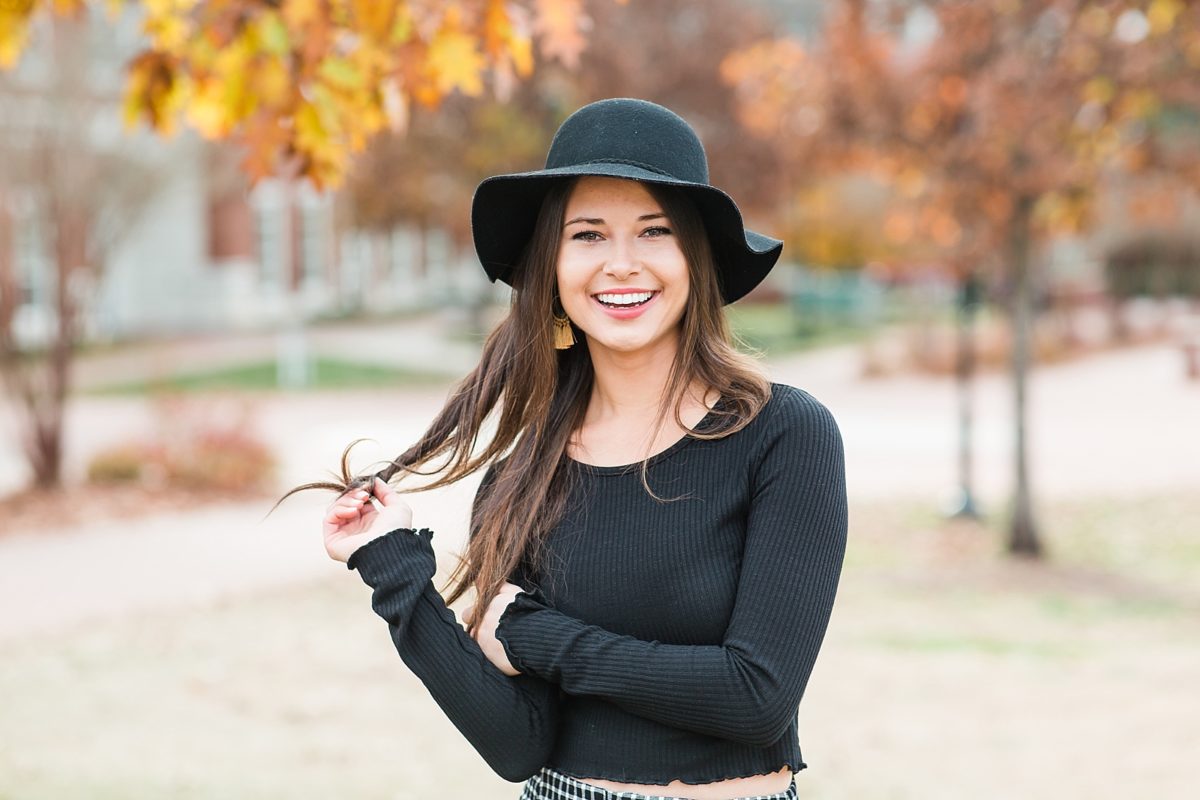 Western Carolina University College Graduate Sierra twirling her hair smiling at the camera photo