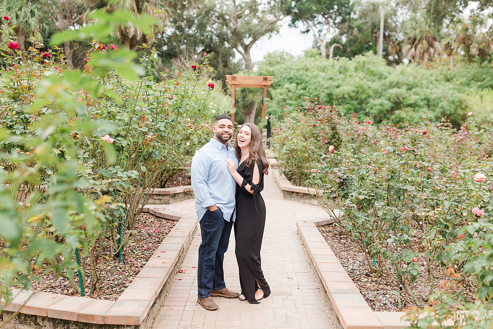 St. Augustine Engagement Couple smiling at the camera in rose garden Photo