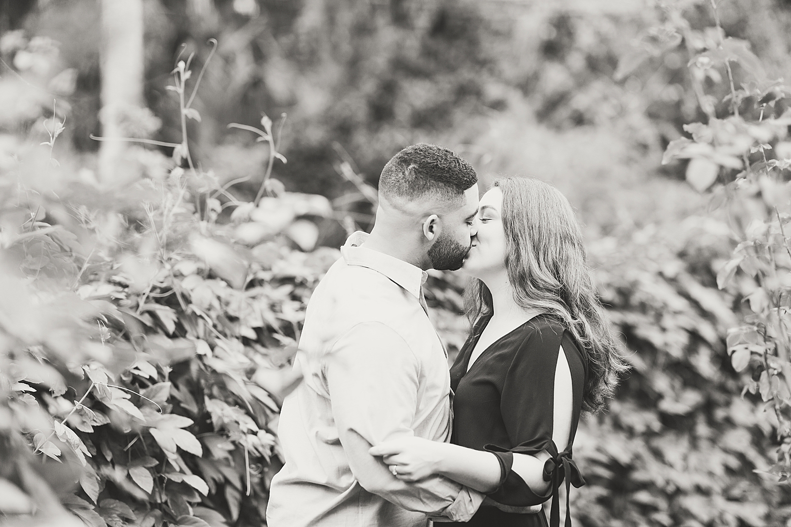 St. Augustine Engagement Black and White couple kissing in garden Photo