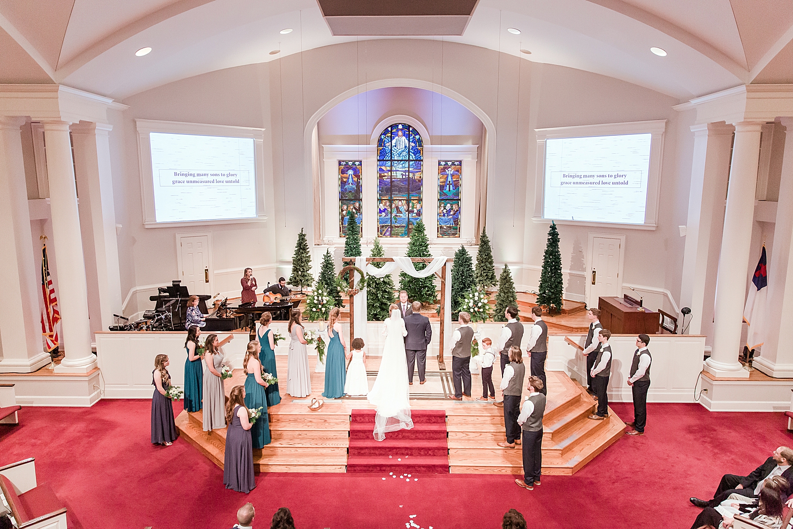 Charlotte Wedding Ceremony Bride and Groom at church alter with all attendants Photo