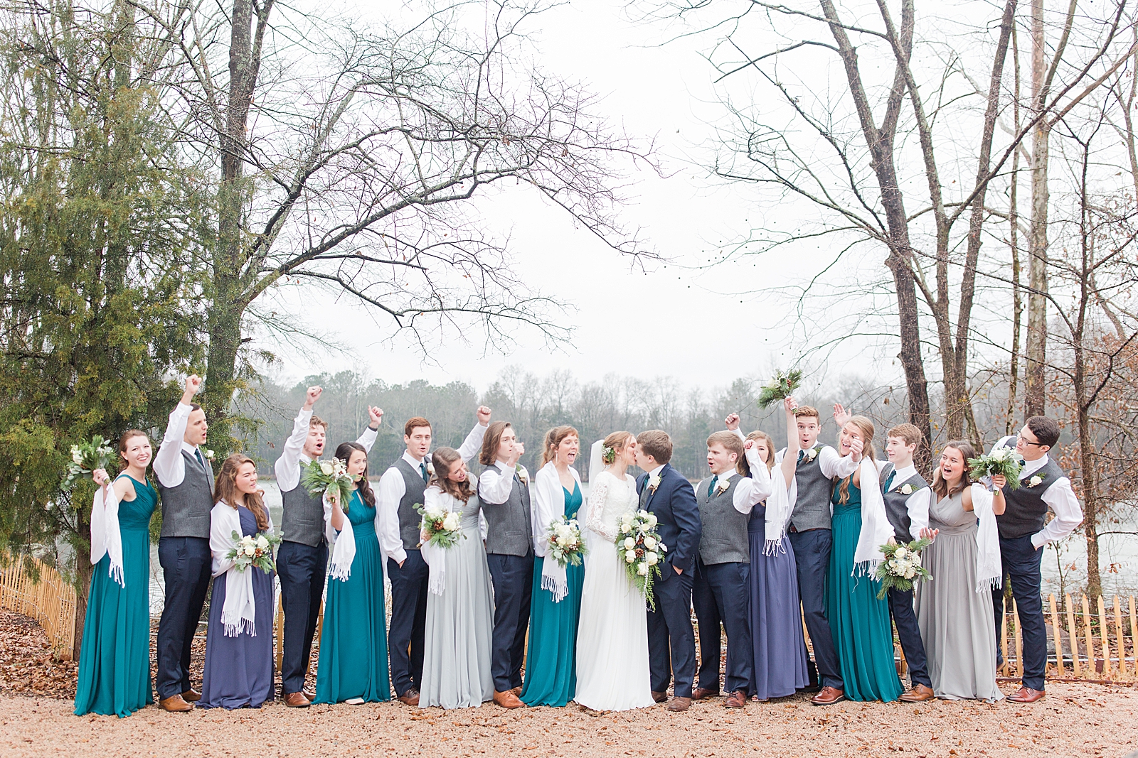 Charlotte Wedding Bride and Groom Kissing and Bridal party Cheering at Riverwood Manor Venue Photo