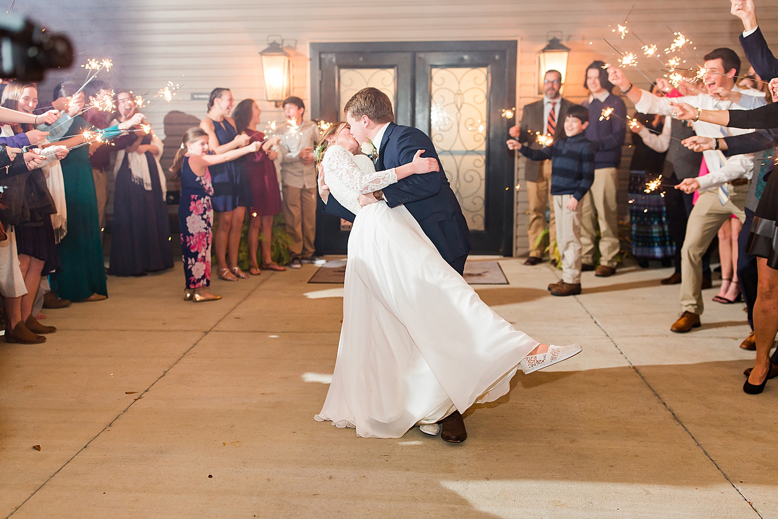 Charlotte Wedding Reception Bride and Groom Kissing During Sparkler Exit Photo