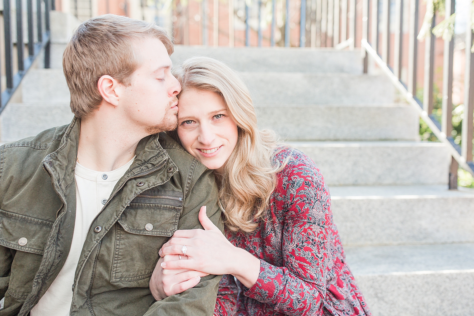 Winston-Salem Engagement Session Chris kissing Katie on the head sitting on stairs Photo