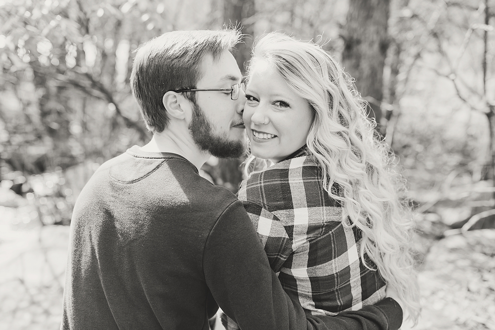 Ocoee River Engagement Session Black and White of Haley looking back over her shoulder and Cody hugging her Photo