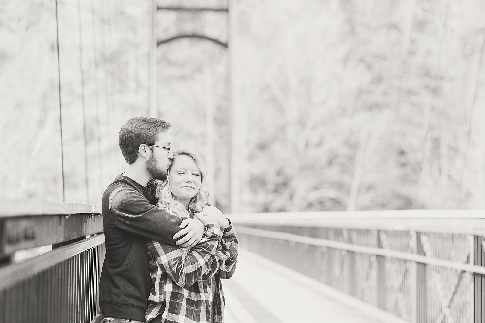 Ocoee River Engagement Session Black and White of Cody and Haley hugging on bridge Photo