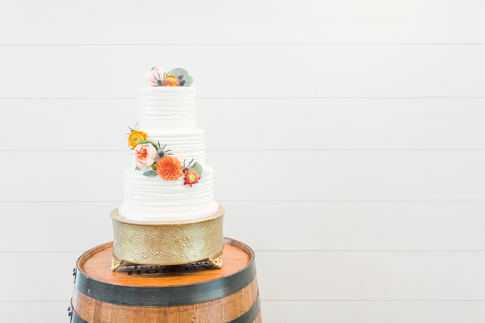 Chestnut Ridge Wedding textured white wedding cake on wood barrel Photo