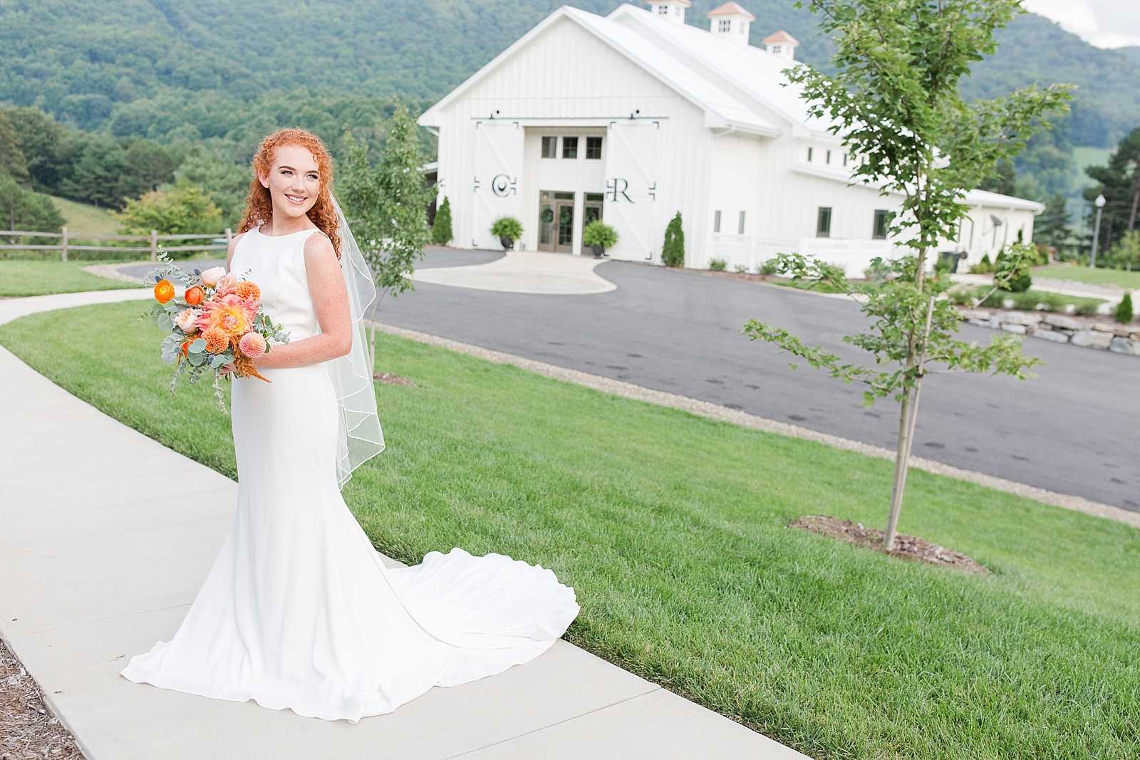 Chestnut Ridge Wedding bridal portrait in front of white barn Photo