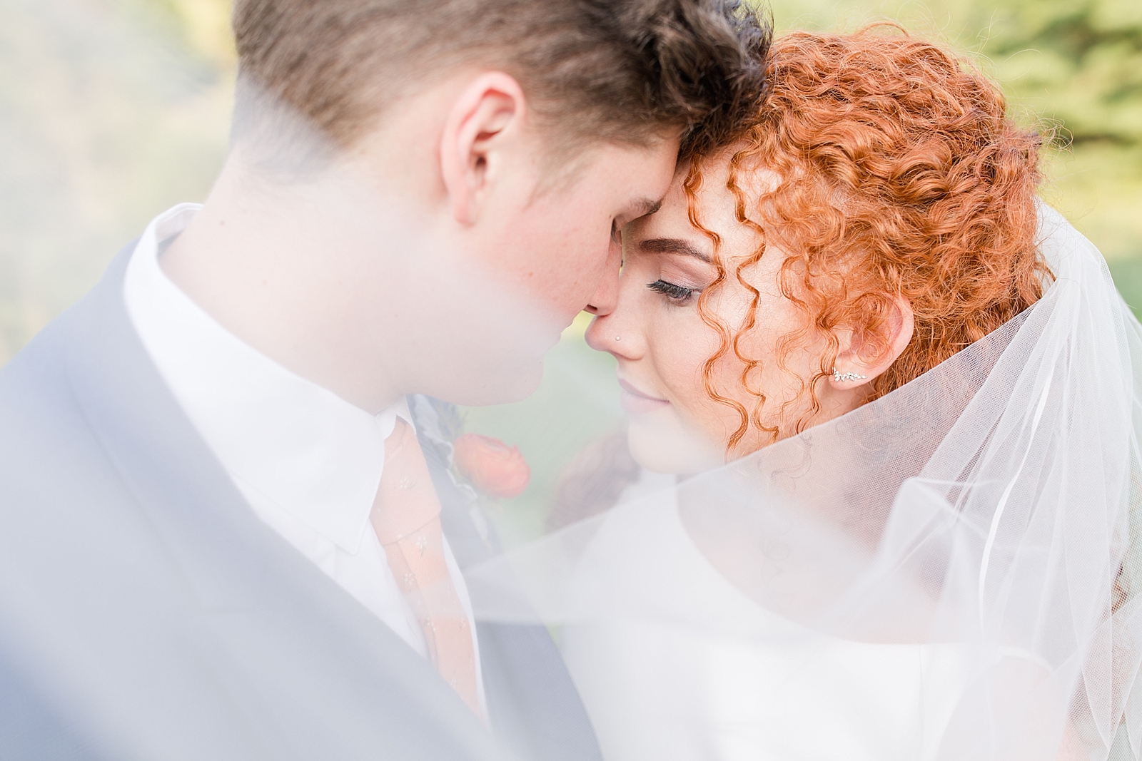 Chestnut Ridge Wedding bride and groom nose to nose veil sweeping in front of camera Photo