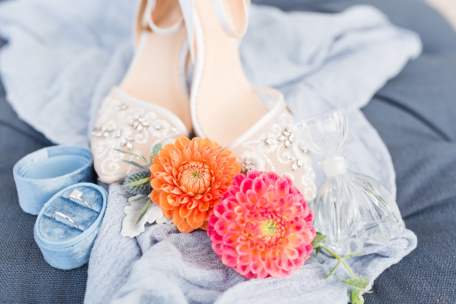 Chestnut Ridge Wedding bridal shoes rings and orange and pink flowers on blue ottoman Photo