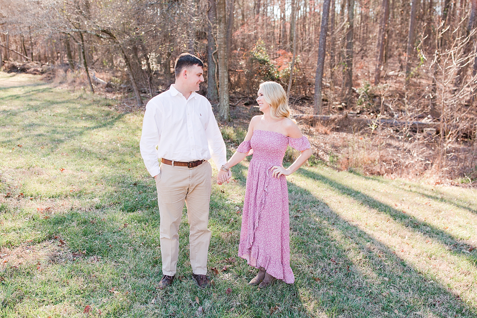Kennesaw Mountain Engagement Session Couple smiling at each other holding hands Photo