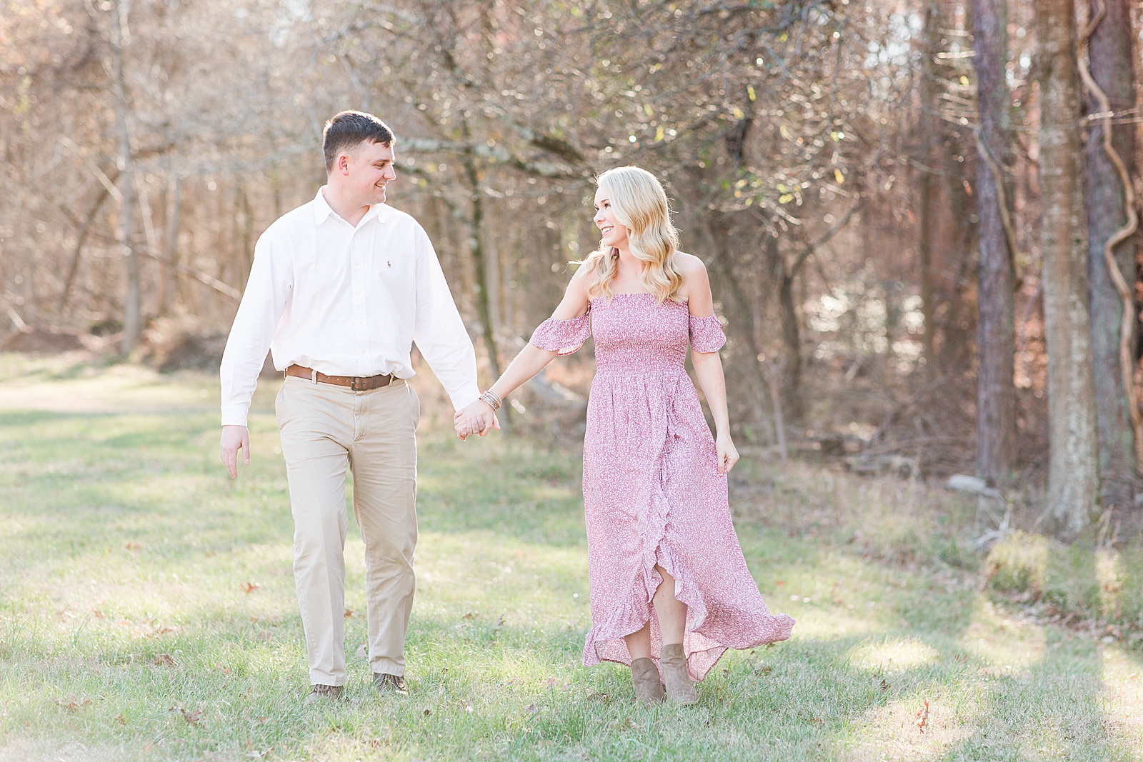 Kennesaw Mountain Engagement Session couple walking smiling at each other holding hands Photo