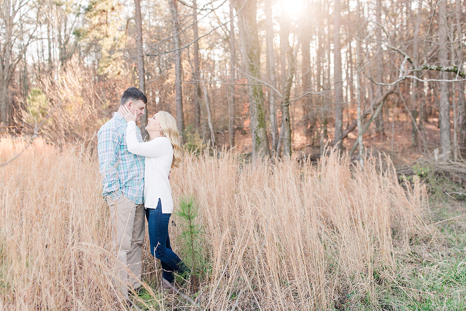Kennesaw Mountain Engagement Session Couple smiling at each other in field of tall grass Photo