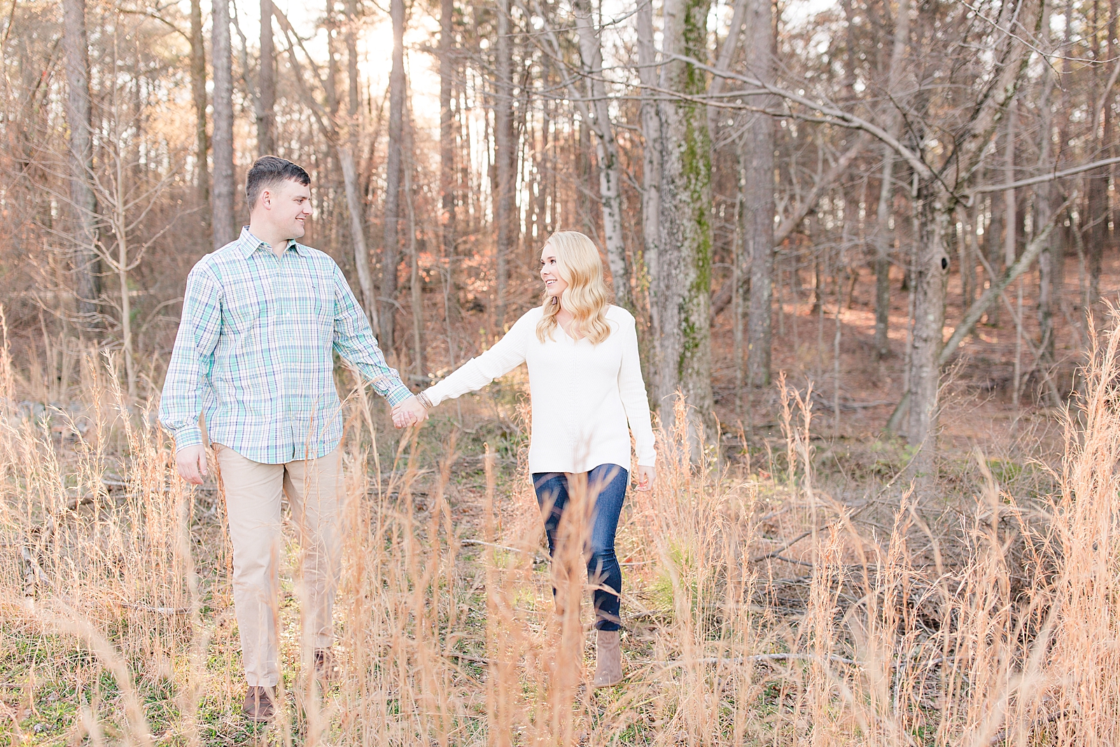 Kennesaw Mountain Engagement Session Couple holding hands in tall grass Photo