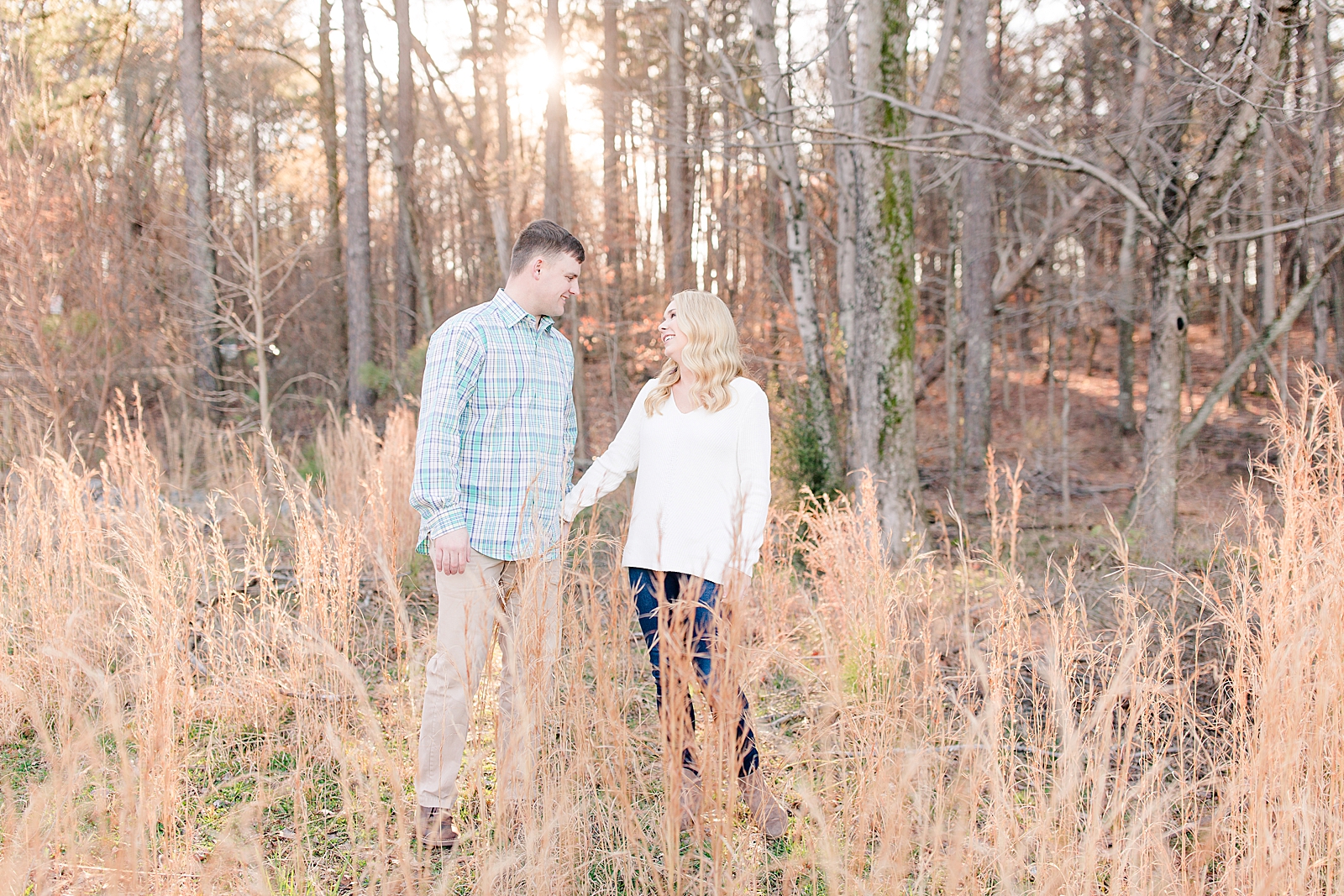 Kennesaw Mountain Engagement Session Couple in tall grass smiling at each other Photo