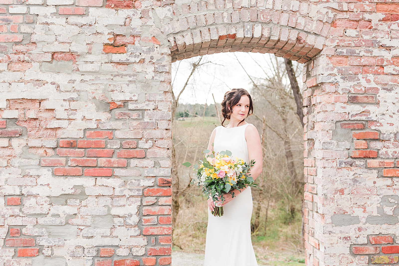 Hackney Warehouse Spring Bridal Session Bride in brick window opening Photo