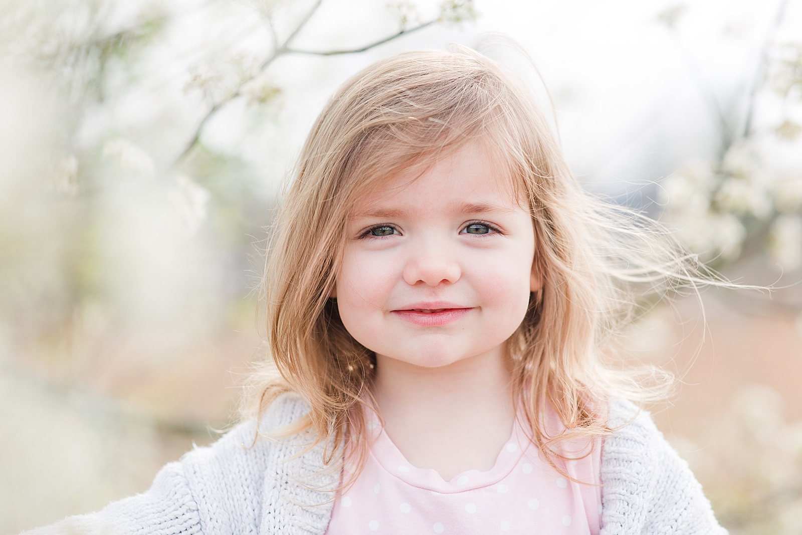 Asheville Photographer's Family Little girl grinning at camera with hair blowing in wind Photo