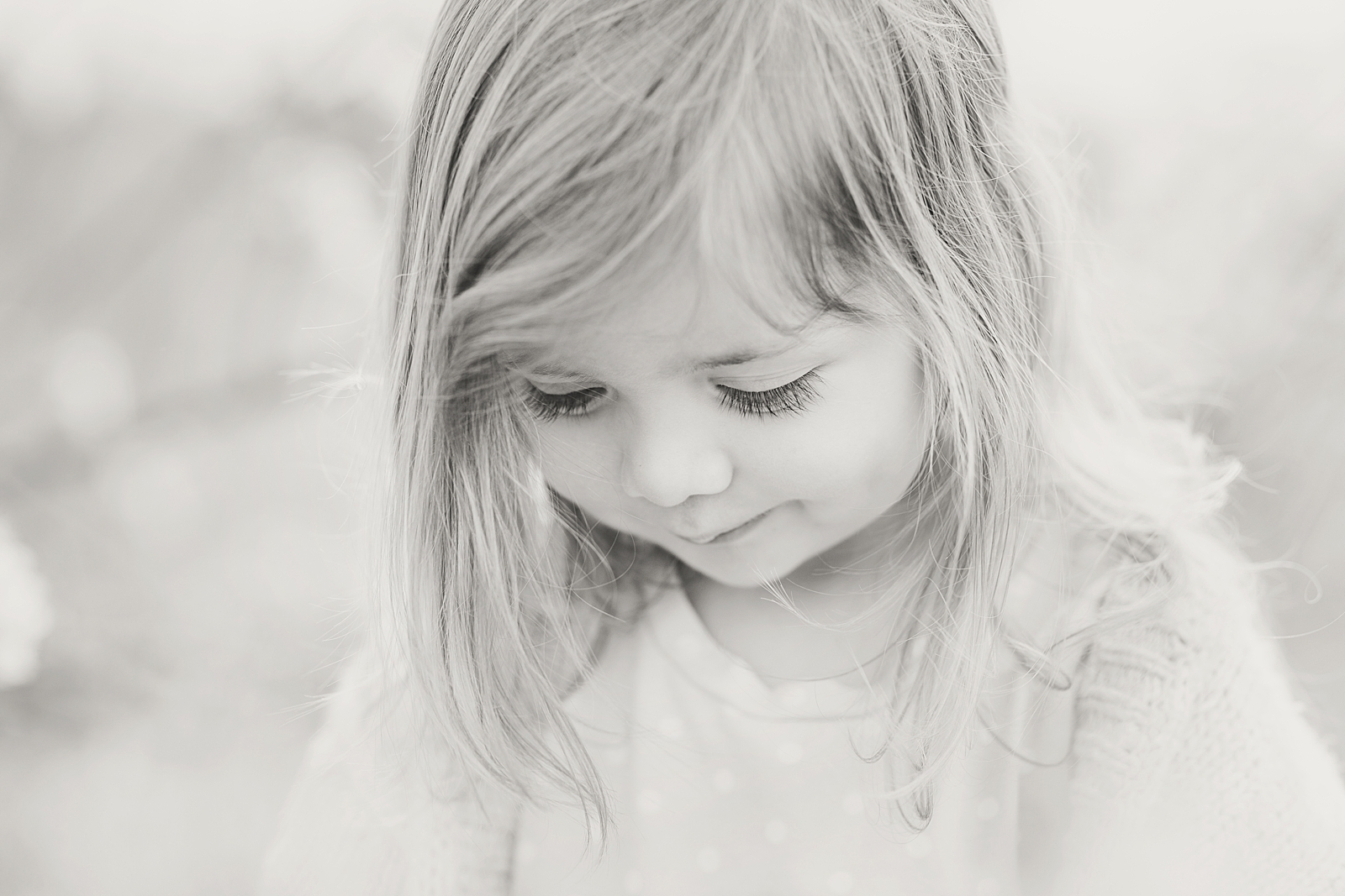 Asheville Photographer's Family Black and white of little girl looking down with pursed lips Photo