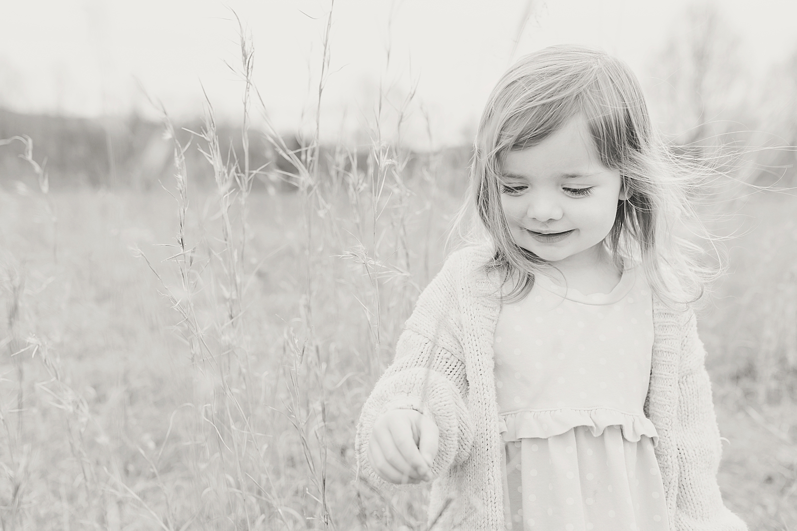 Asheville Photographer's Family black and white of little girl with wind blowing in the wind Photo
