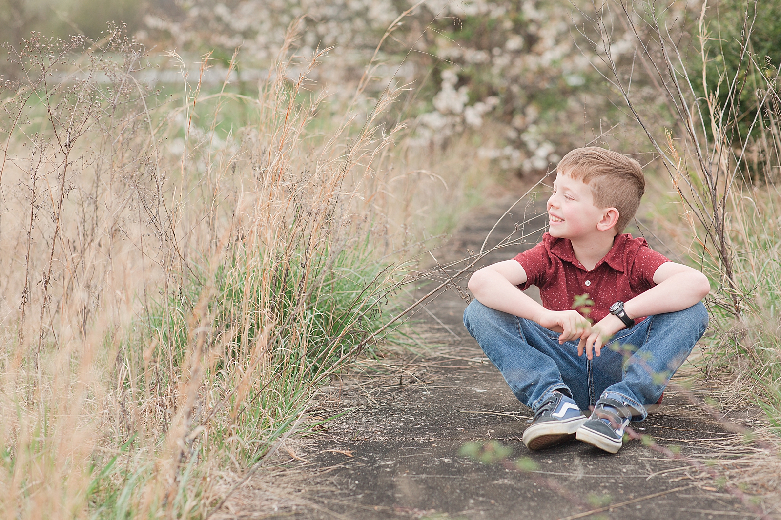 Asheville Photographer's Family Little boy sitting on side walk smiling off Photo