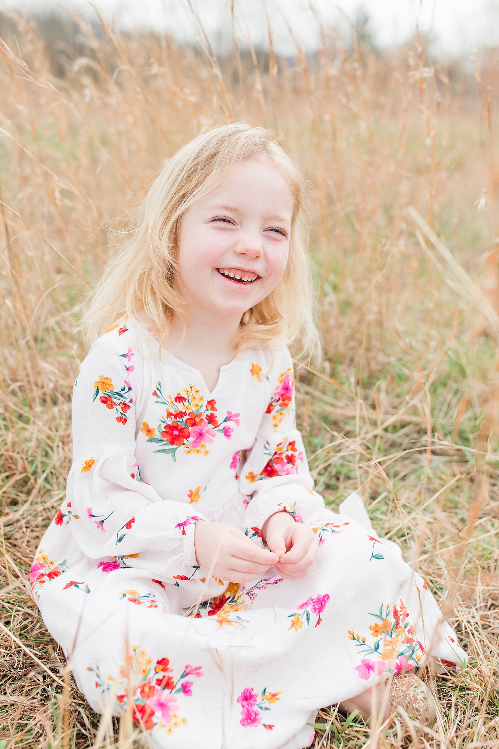 Asheville Photographer's Family little girl laughing in tall grass Photo